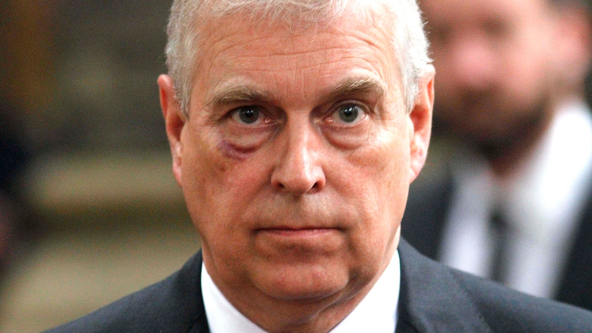 A close-up of Prince Andrew wearing a black blazer.