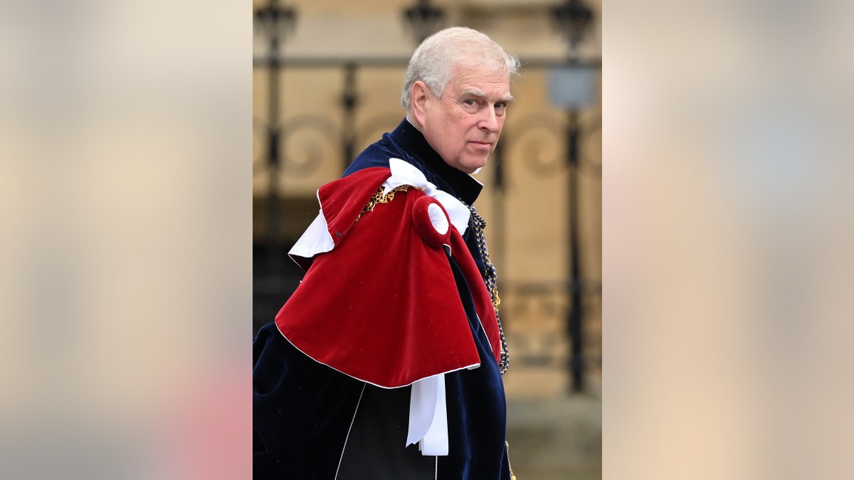 Prince Andrew wearing a royal robe looking upset.