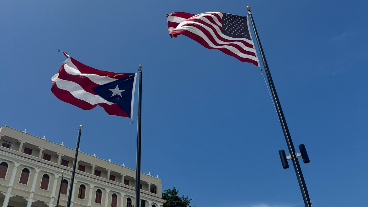 Puerto Rico and United States flags side by side blowing in the wind