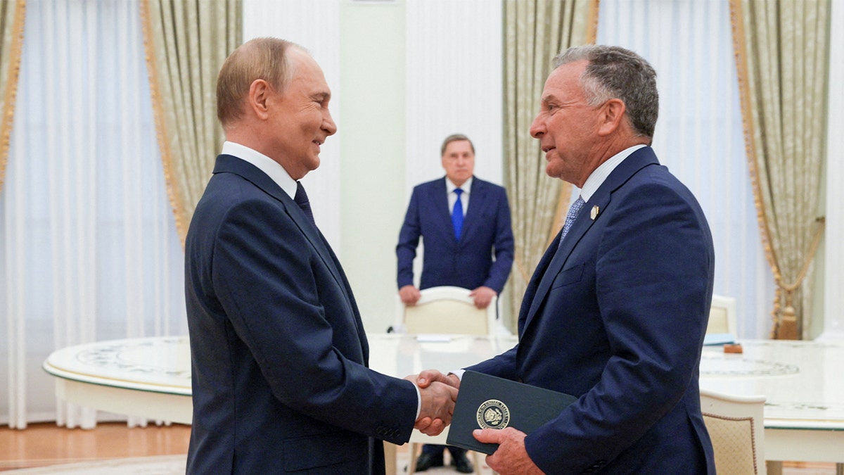 Russian President Vladimir Putin and U.S. Special Envoy Steve Witkoff shake hands