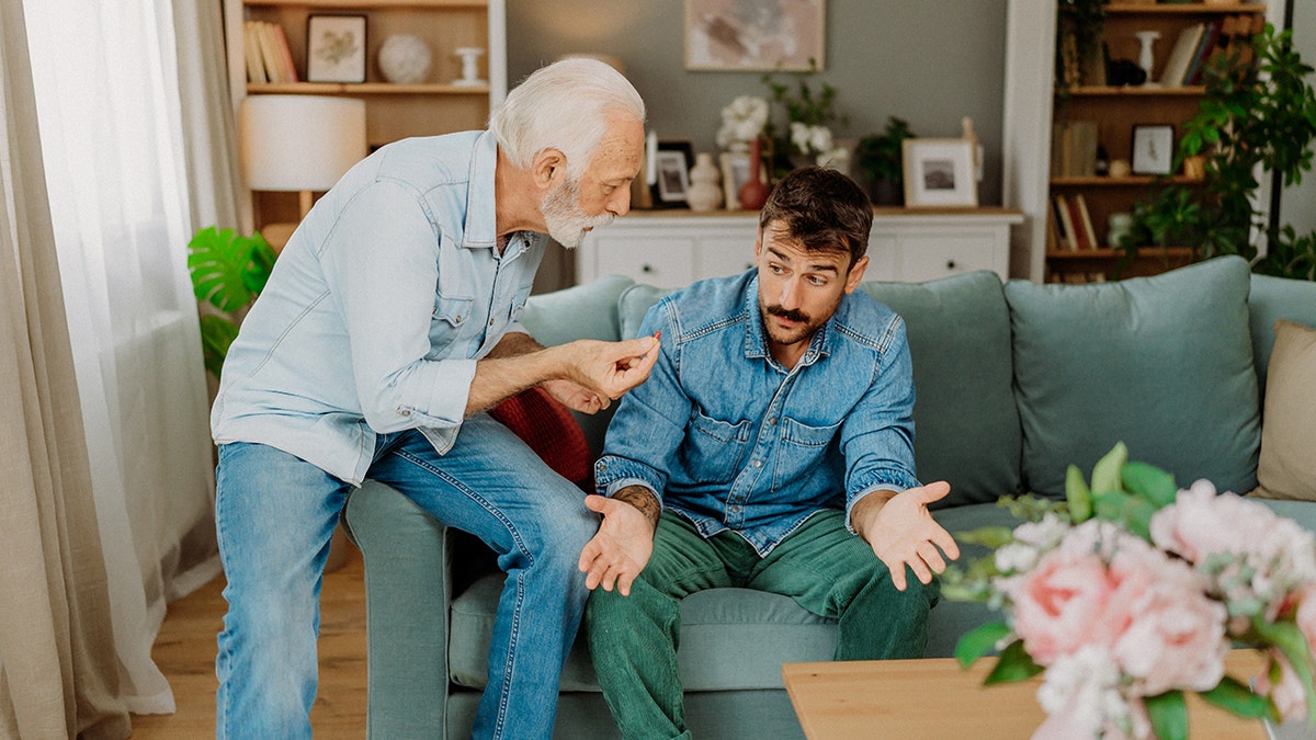 Older man arguing with young man