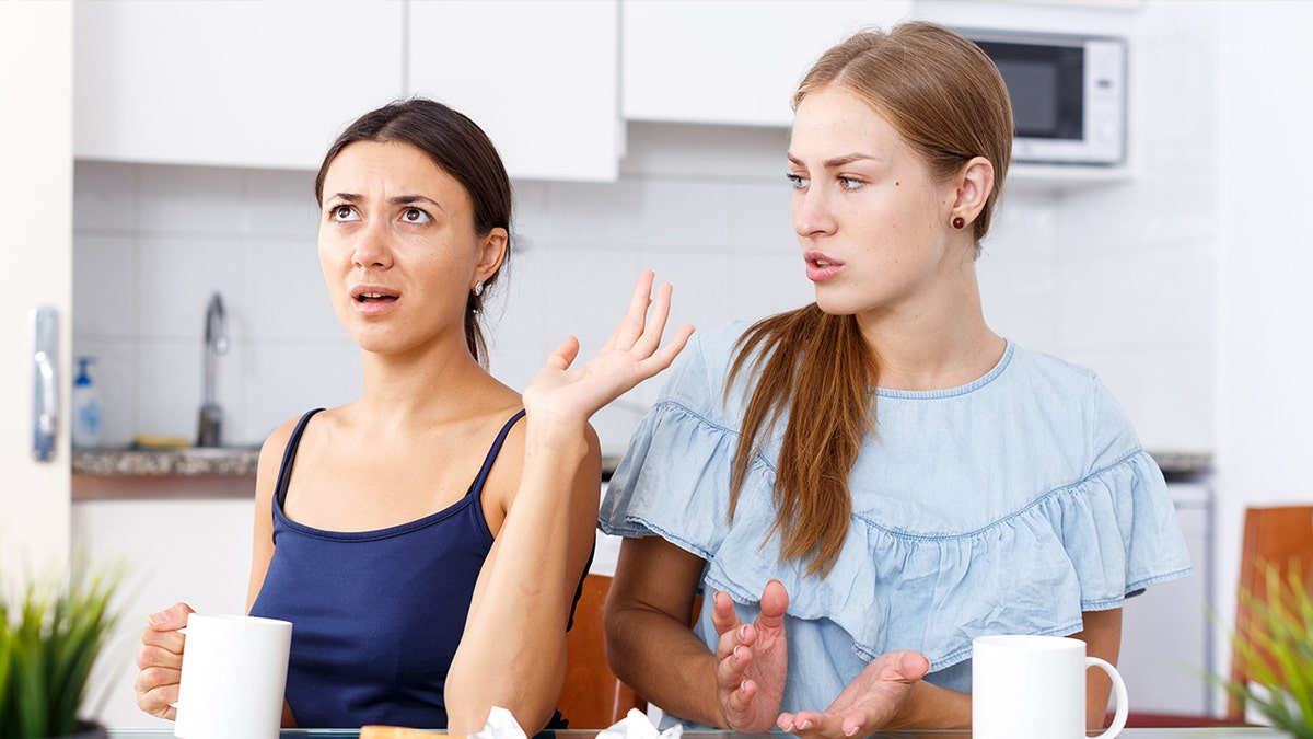 Two women arguing in kitchen