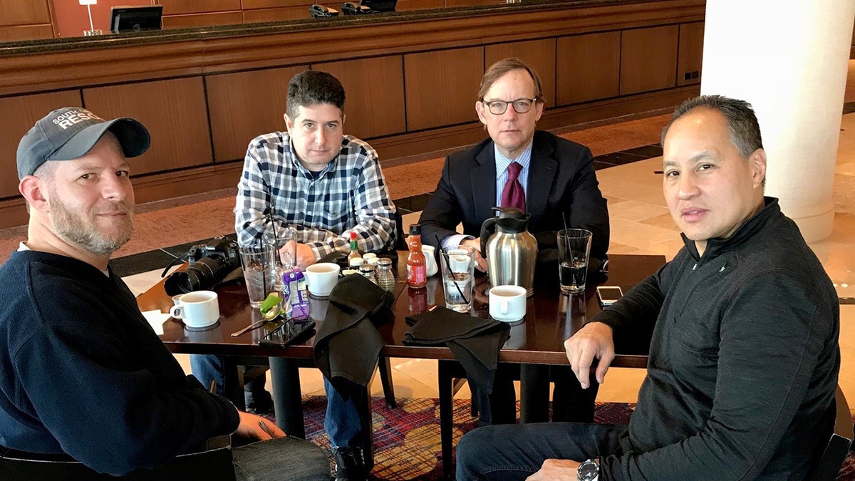 Four people sitting at a table