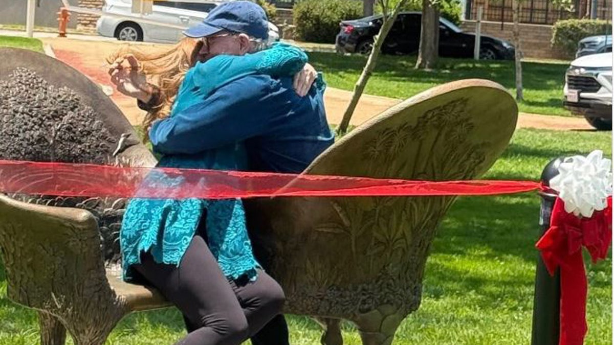Ron Howard and his wife embrace in the kissing chair