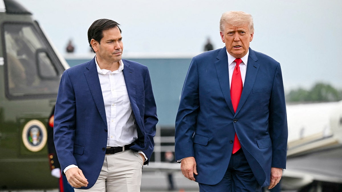 Secretary of State Marco Rubio and President Donald Trump walk to speak with reporters