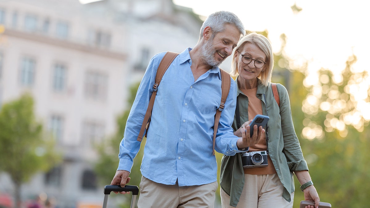 Two older adults smiling on vacation