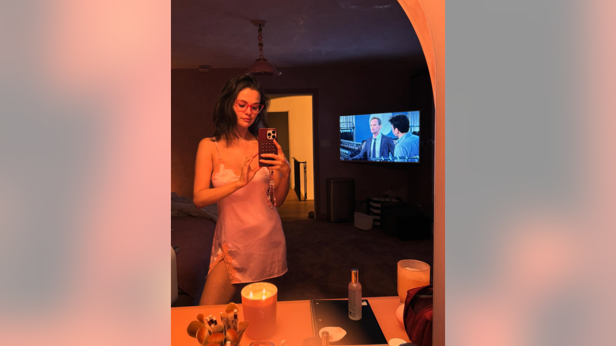 Selena Gomez takes a selfie in a piece of pink satin lingerie