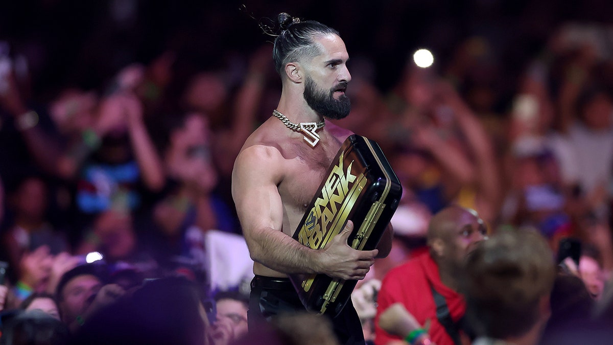 Seth Rollins runs along the ramp