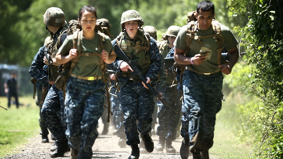 Members of the United States Naval Academy freshman class take part in a ruck run, before the exercise took off as a new workout trend online