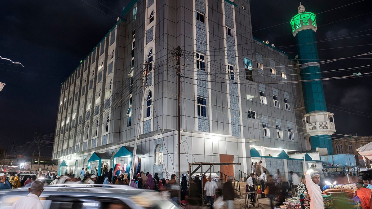 People walk in front of a mosque in the city of Hargeisa, Somaliland, on September 16, 2021.