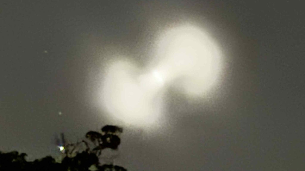 Pill-shaped orb in darkened sky