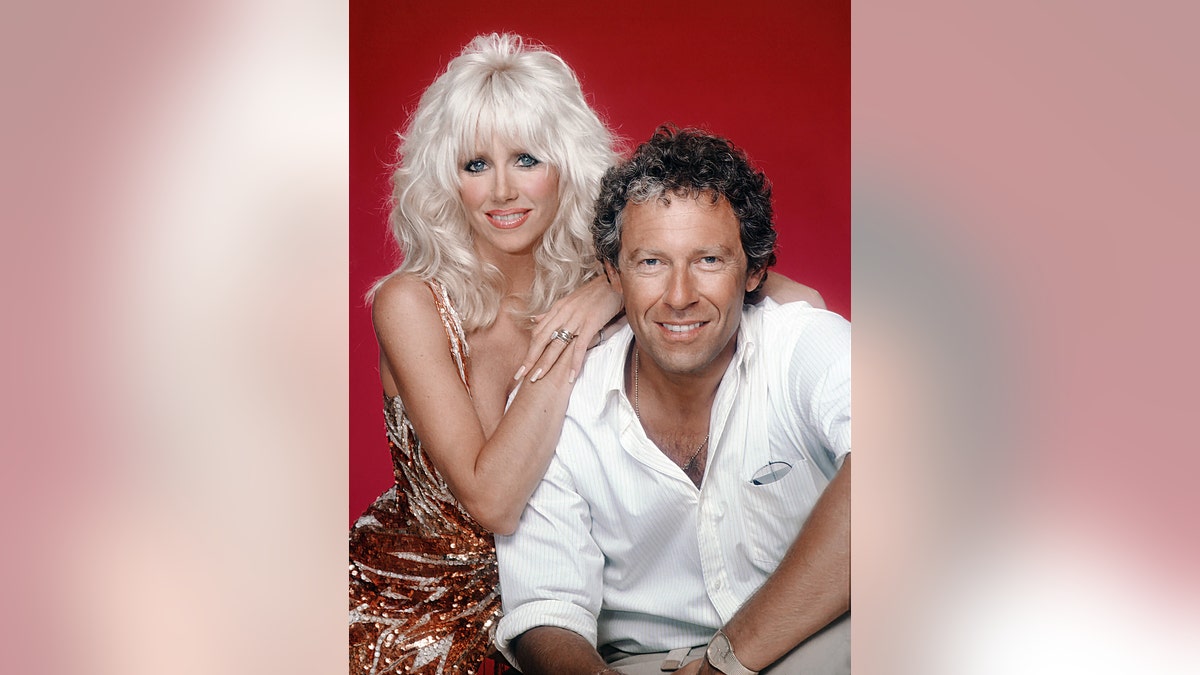 A young Suzanne Somers and Alan Hamel posing together.