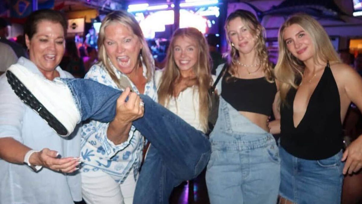 Sydney Sweeney is seen kicking her leg up and posing with her friends. 