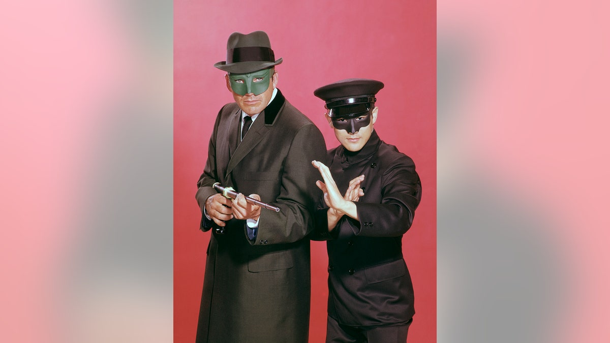 The cast of "The Green Hornet" in costume wearing masks.