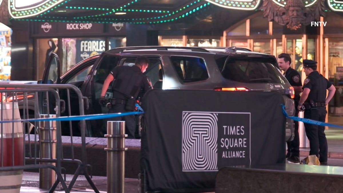 Police search an SUV in Times Square
