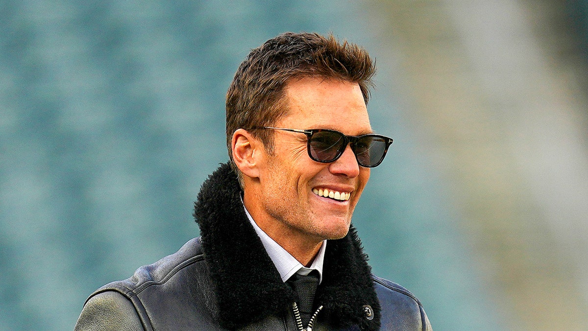 Tom Brady smiles on field