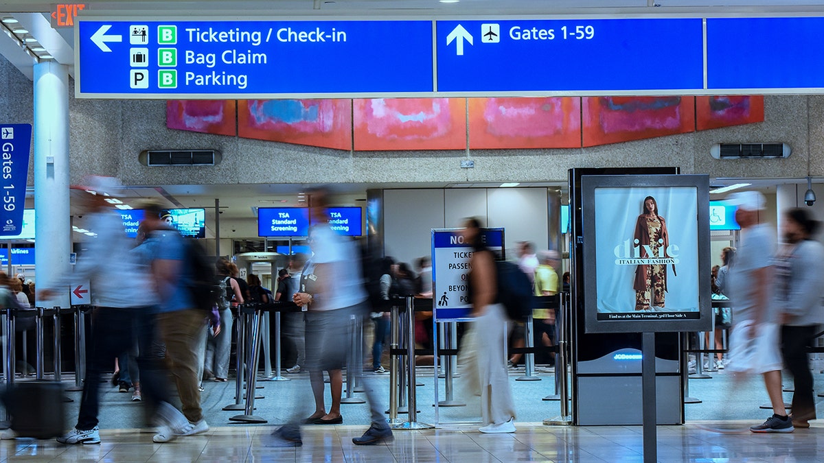 Travelers make their way through Orlando International Airport during the busy Labor Day holiday weekend in Orlando.
