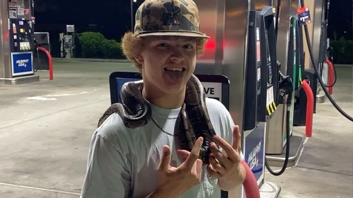 trey wright posing with a snake on his shoulders