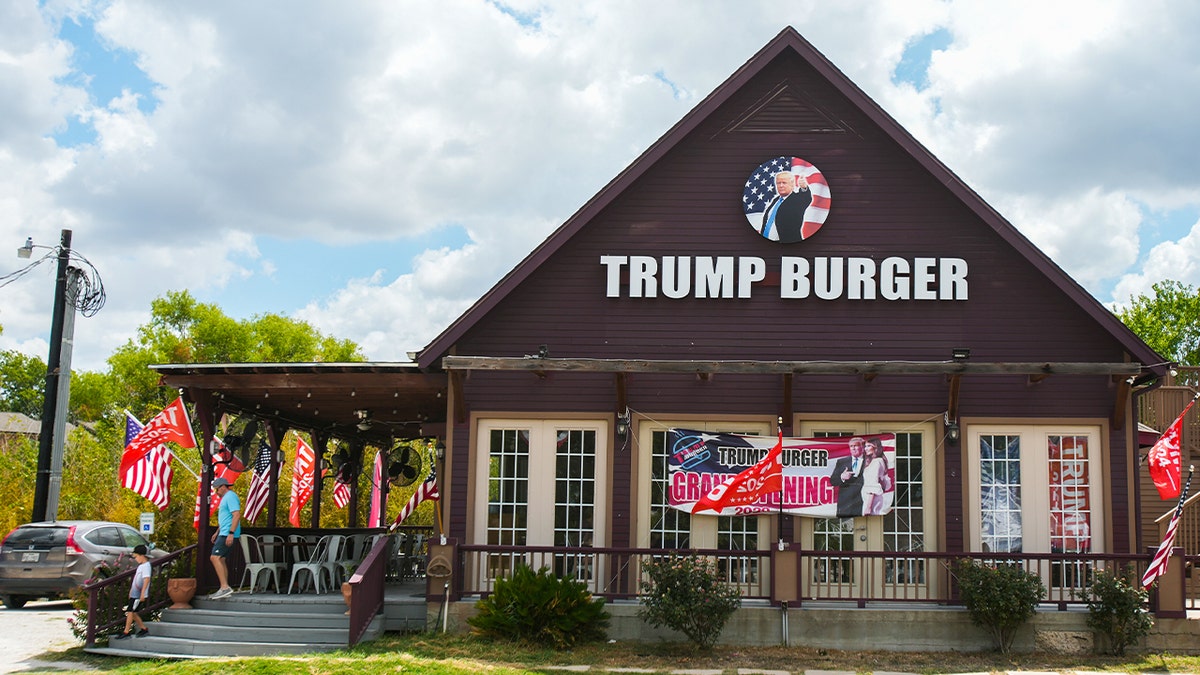 Brown building of Trump burger with photos of trump, trump flags and american flags