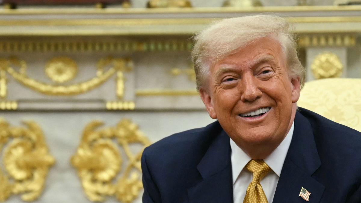 US President Donald Trump smiles in the Oval Office