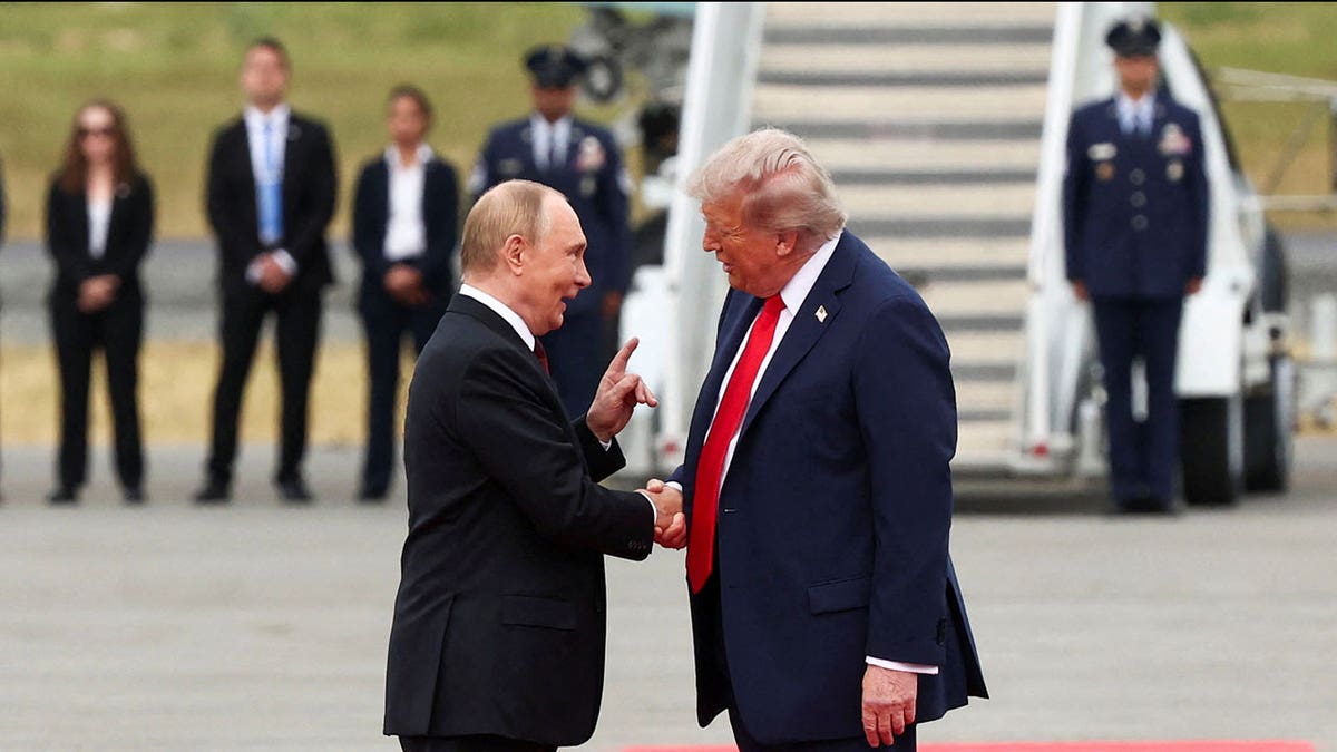 Trump and Putin greet each other on the tarmac