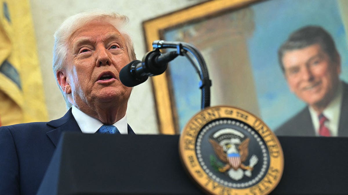 Trump speaks in front of portrait of Ronald Reagan