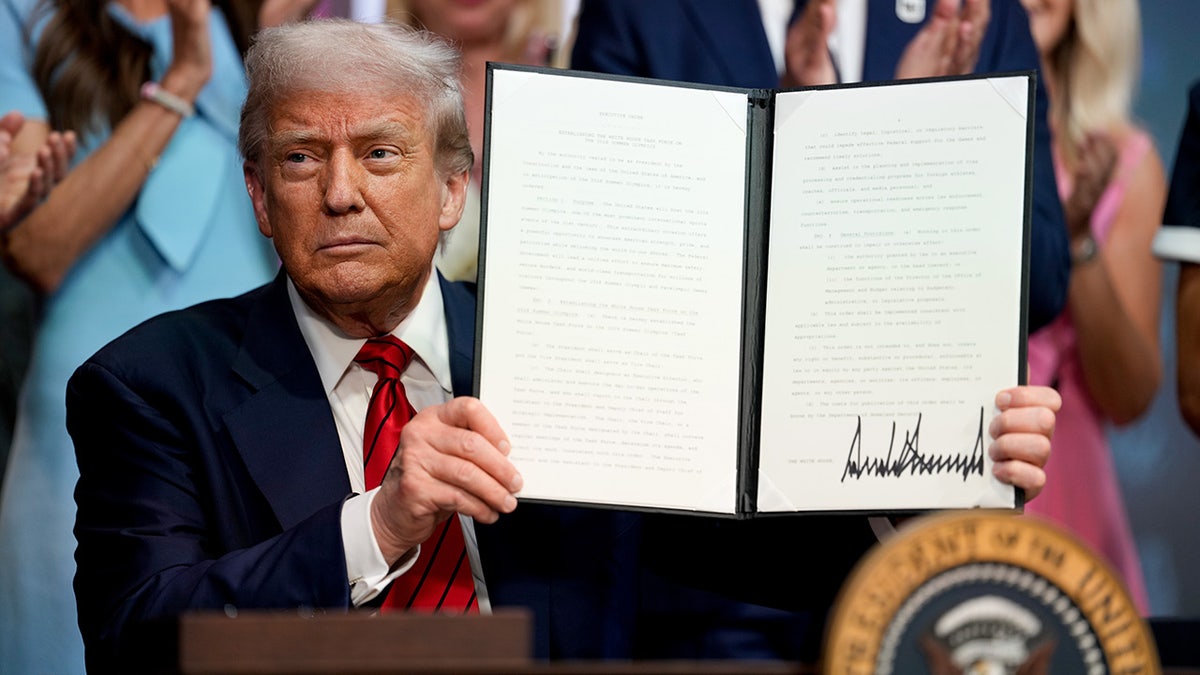 Trump signs an executive order at the White House