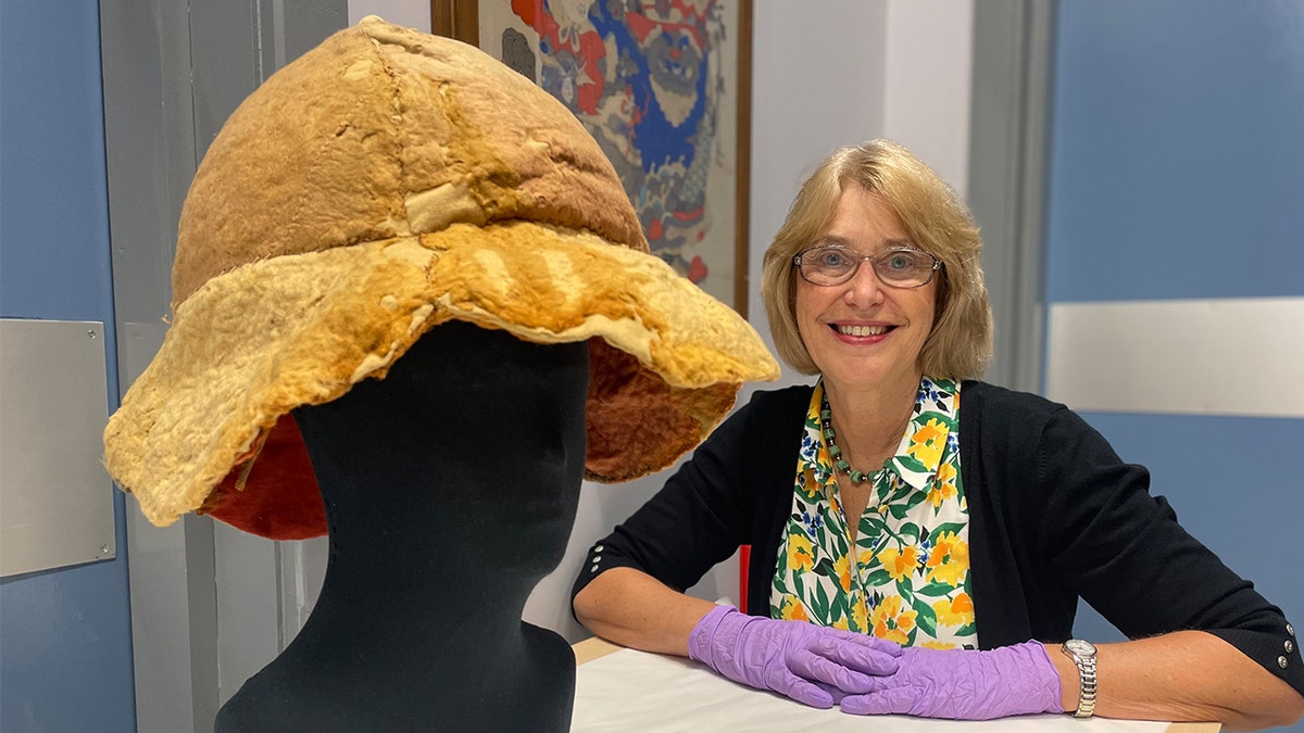 Woman smiling next to preserved sun hat