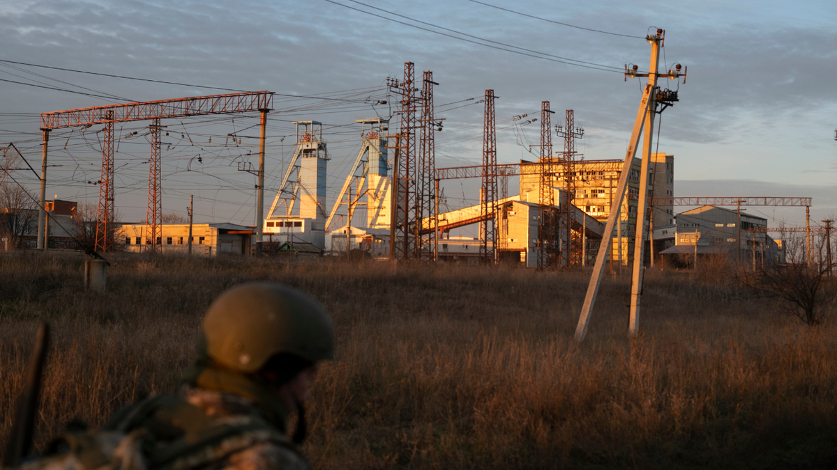 A soldier walks near the damaged Artyomsol salt mine in Ukraine