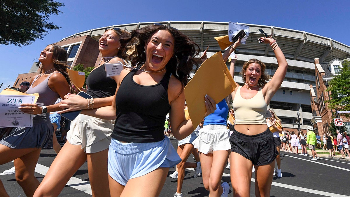 College girls running after being picked for a sorority at the University of Alabama