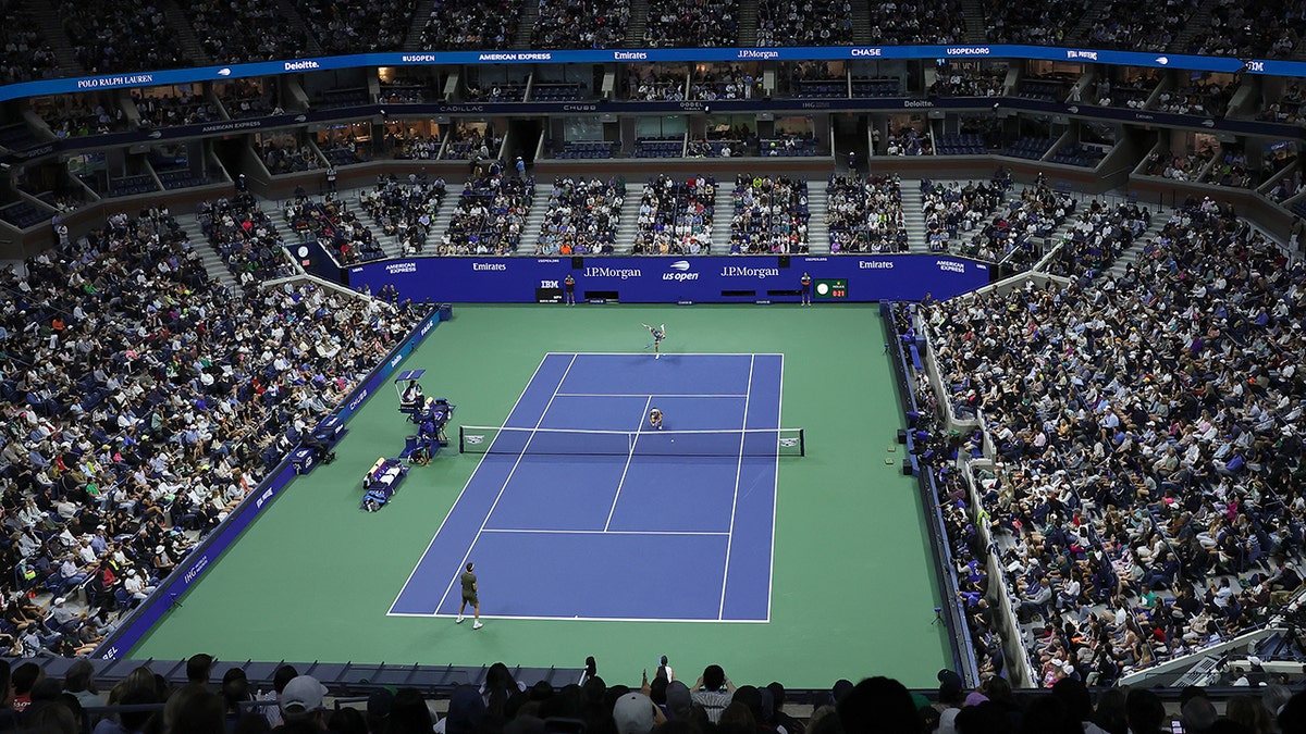 Jack Draper of Great Britain plays teammate Jessica Pegula of the United States during the Mixed Doubles Semifinal at USTA Billie Jean King National Tennis Center on August 20, 2025 in New York City. Court and crowds in stands seen from aerial view