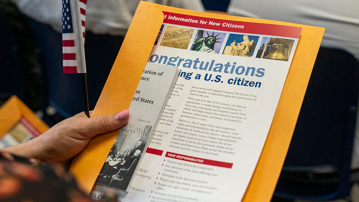 Someone holding a citizenship paper 
