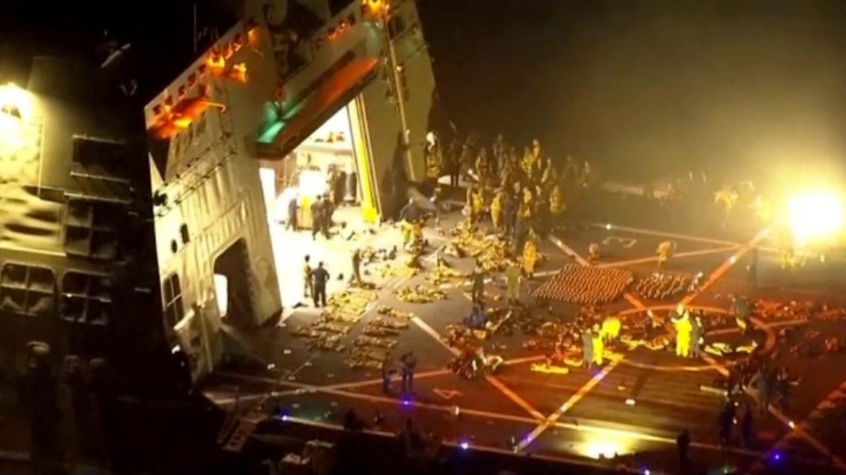 crews helping to extinguish fire aboard USS New Orleans