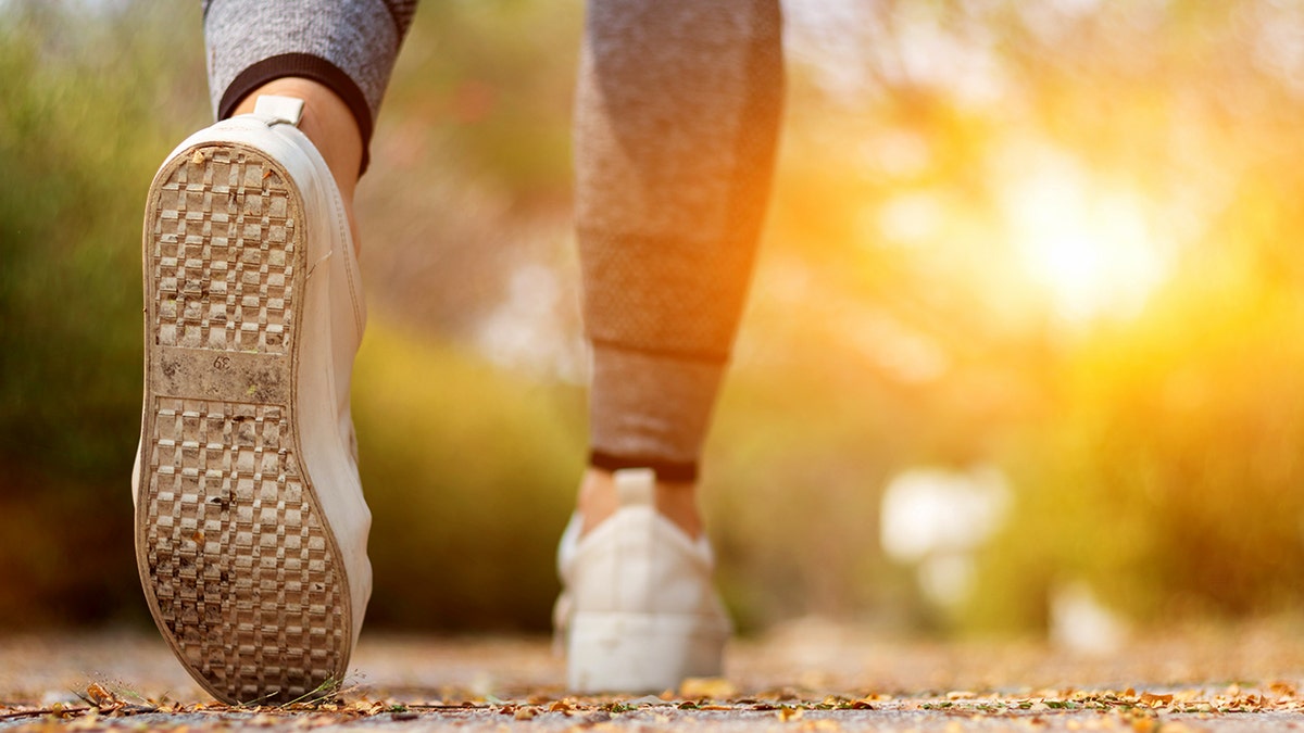 Close -up of sneakers while the woman is going to walk outside
