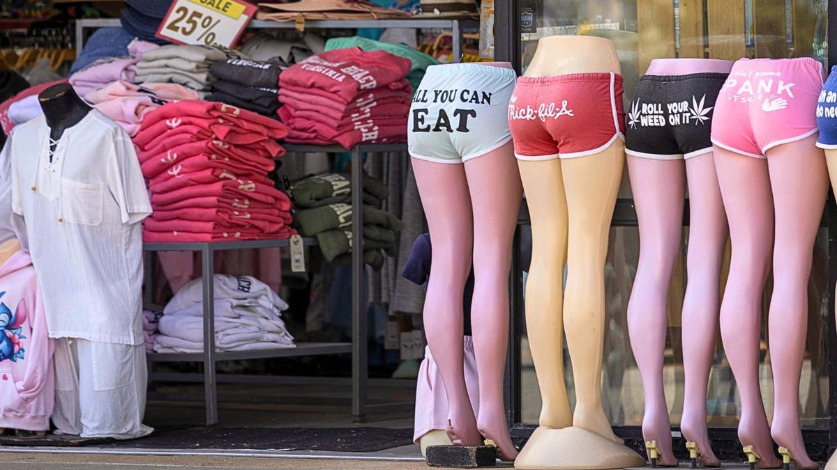 Mannequin legs and t-shirts on display