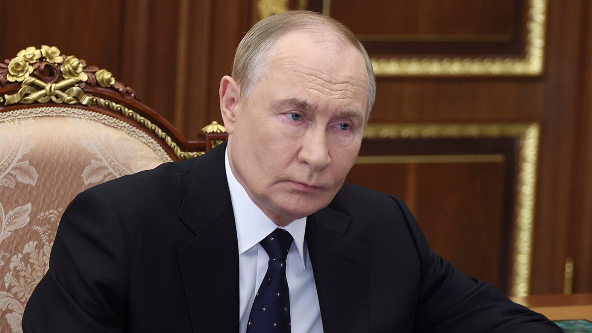 Russian President Vladimir Putin listens to the meeting