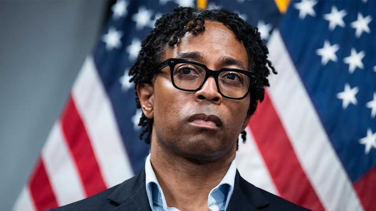 Rep. Wesley Bell of Missouri in front of American flags