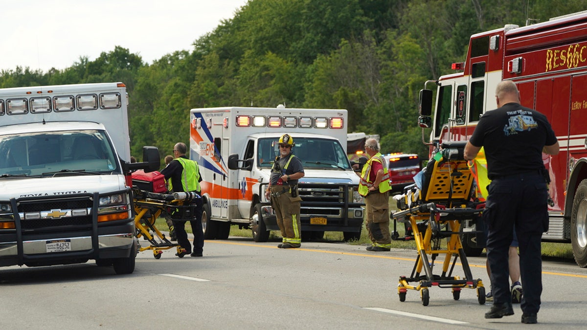 Rescue personnel work the scene of a tour bus that crashed and rolled over on the New York State Thruway near Pembroke, N.Y., Friday, Aug. 22, 2025.