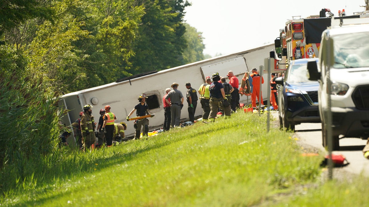 First responders work to rescue victims at the scene of a tour bus that crashed and rolled over on the New York State Thruway near Pembroke, N.Y., Friday, Aug. 22, 2025.