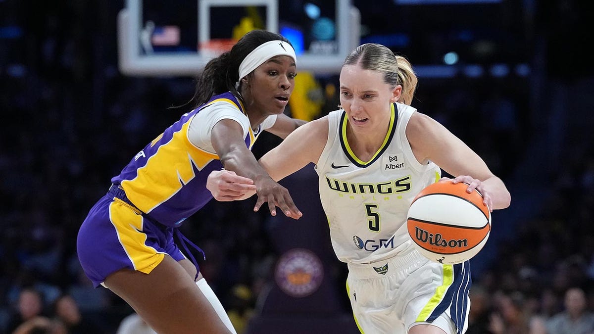 Paige Bueckers goes past Rickea Jackson