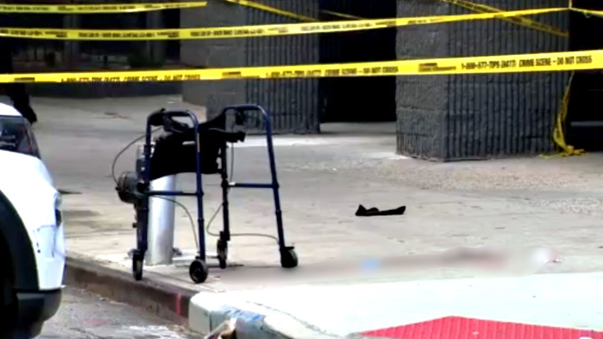 A walker on a New York City street at a crime scene.
