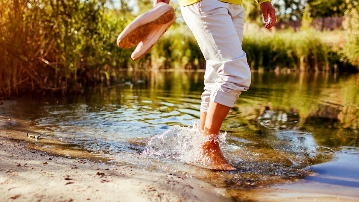 Woman wading in shallow water