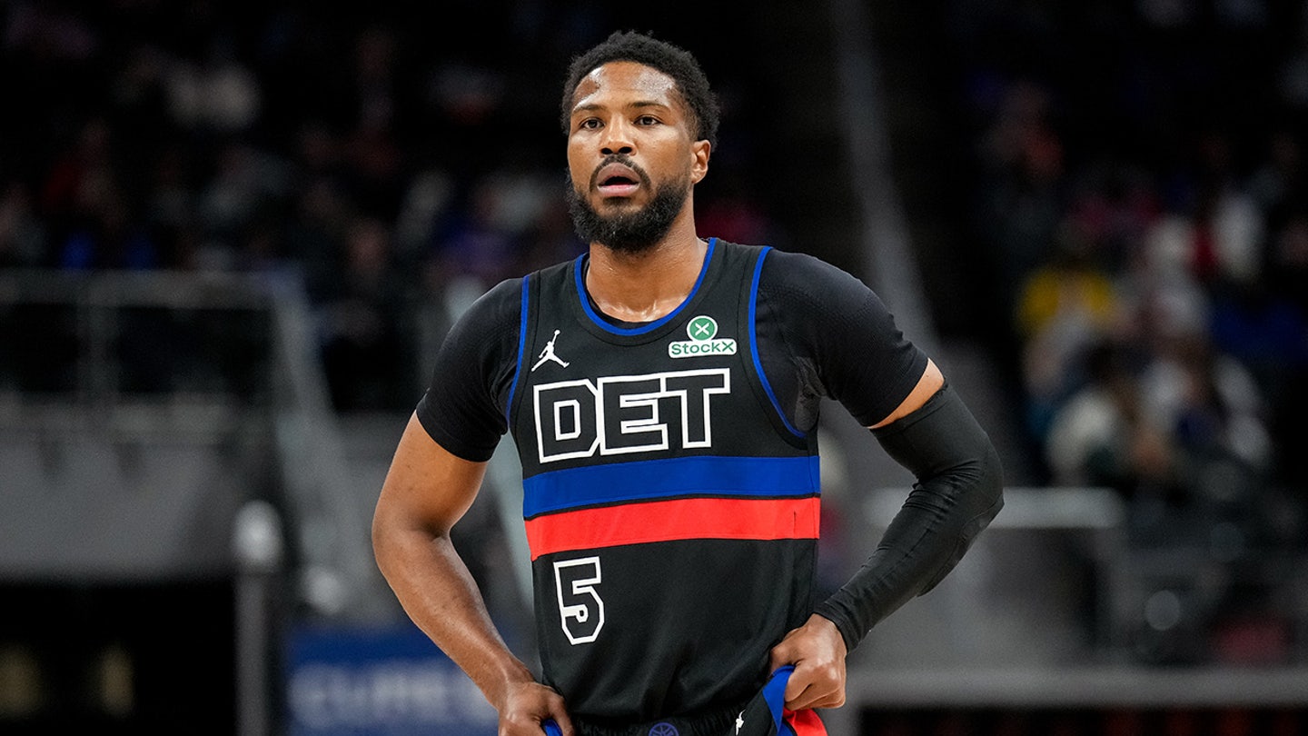 Malik Beasley looks on during a game
