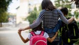Mother with arms around two kids