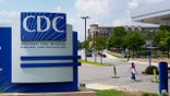 People walk outside the CDC campus in Atlanta