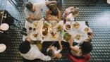 Aerial shot of family out to dinner including two young kids