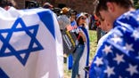 Demonstrators draped in Israeli and US flags