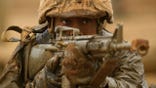 TOPSHOT - A female United States Marine Corps (USMC) recruit from Lima Company, the first gender integrated training class in San Diego, aims their rifle while covered in mud following an obstacle course during The Crucible, the final part of phase three of recruit training before officially becoming US Marines on April 21, 2021 at Camp Pendleton in San Diego County, California. - Lima Company is the first gender integrated company with a female platoon training alongside male platoons at the west coast Marine Corps Recruit Depot, San Diego (MCRDSD). The Crucible is the final 54-hour test for the recruits, where upon completion the recruits will receive their eagle, globe, and anchor pin to officially become US Marines. Recruits had to spend two weeks in quarantine before beginning training due to the Covid-19 pandemic. Congress ordered the Marine Corps to fully integrate women into its west coast training battalions by 2028 under the National Defense Authorization Act. Women make up about 9 percent of the Marine Corps. (Photo by Patrick T. FALLON / AFP) (Photo by PATRICK T. FALLON/AFP via Getty Images)