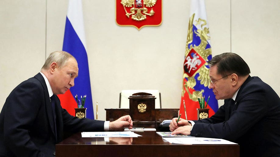 Putin sits with Rosatom's Alexey Likhachev