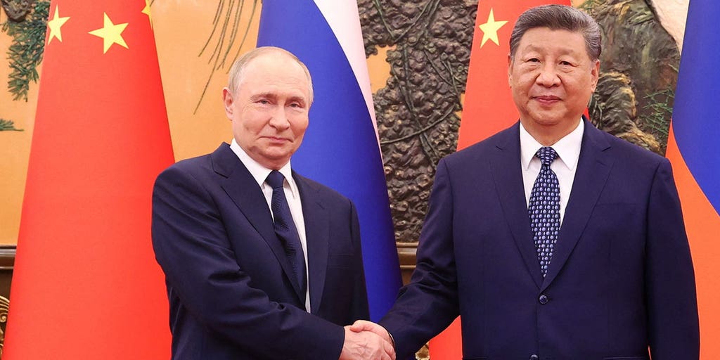 Xi Jinping and Vladimir Putin at the Beijing event